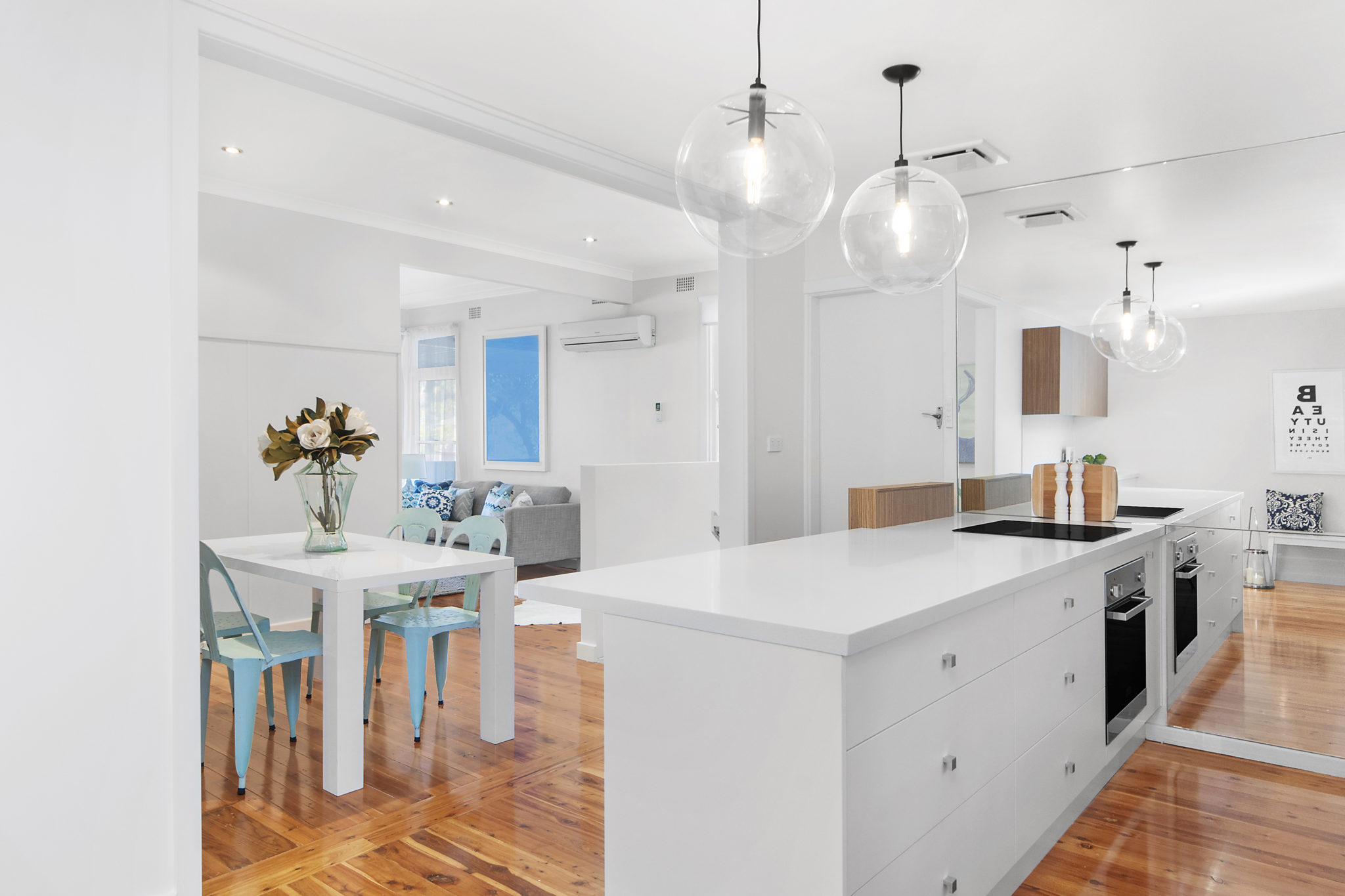 Pops of cool blue tones in the furniture, accessories and furnishings bring a cool feel to the space, while a mirrored wall helps bounce light around and make the area brighter and bigger.  