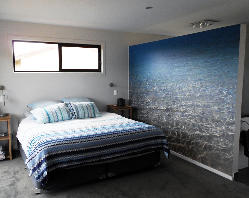 This was installed in a beach house in Phillip Island. Andrea took her own close up image of the water and created a wall mural. The wall separates the en suite from the master bedroom.