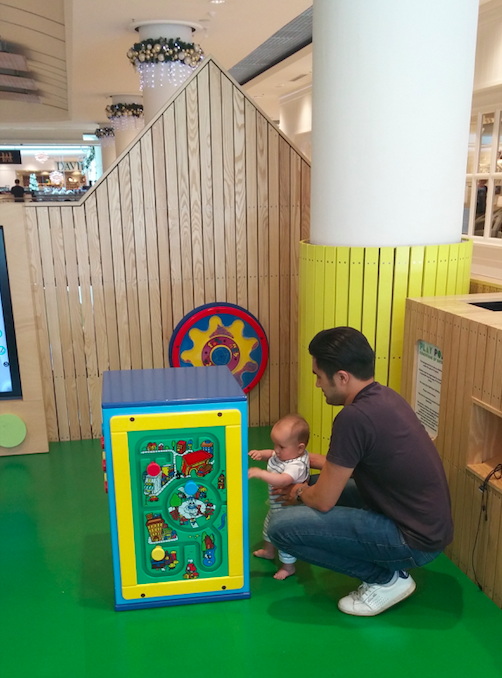 Sebastian enjoys the play area with Daddy