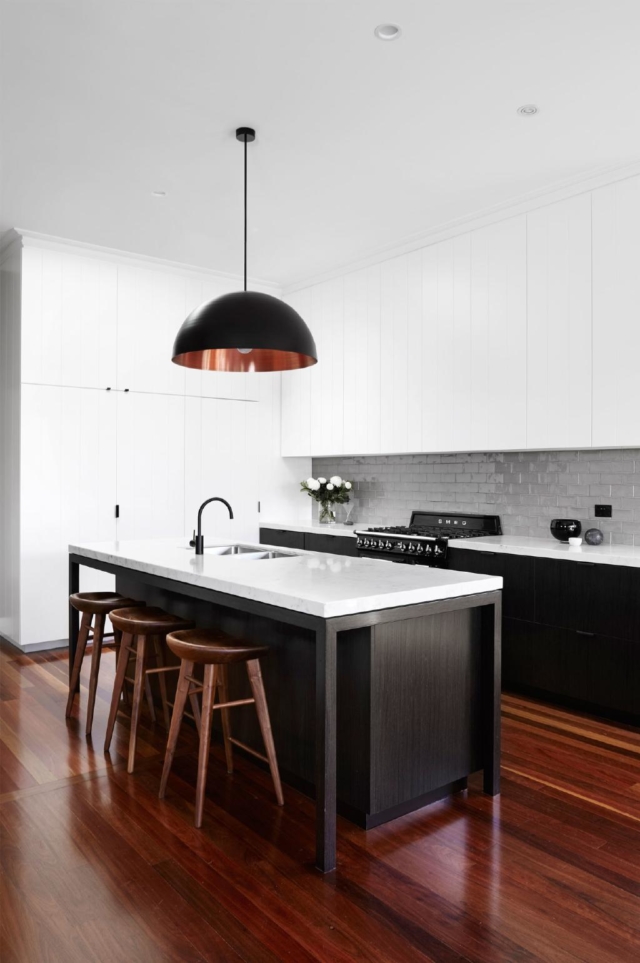 The timber floor provides warmth in this monochrome kitchen. Image source: Pinterest/A Girl Called Fred