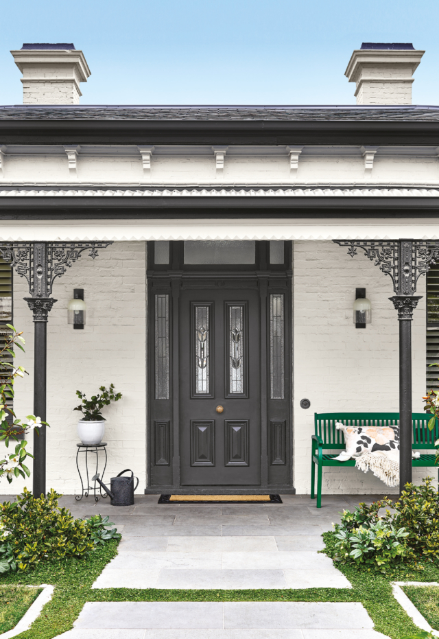 The upcycled green bench seat makes a front porch statement