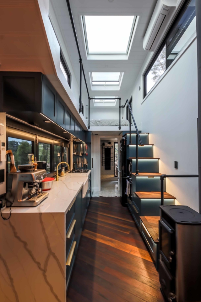 The compact kitchen looking up to one of the loft bedrooms. The stairs contain storage inside them.