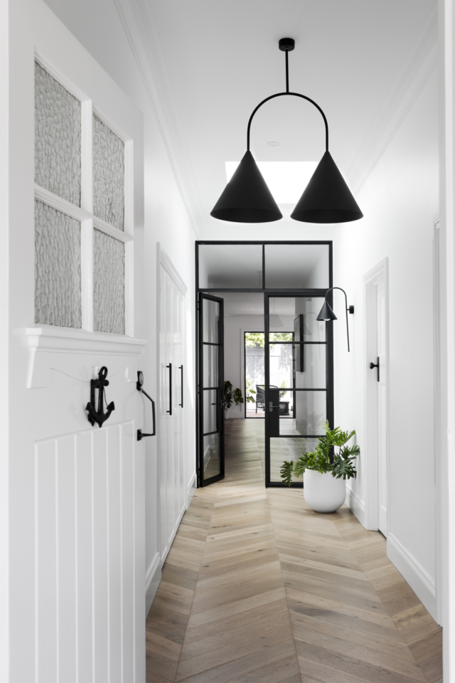 Black door frames separate the old and new parts of the home