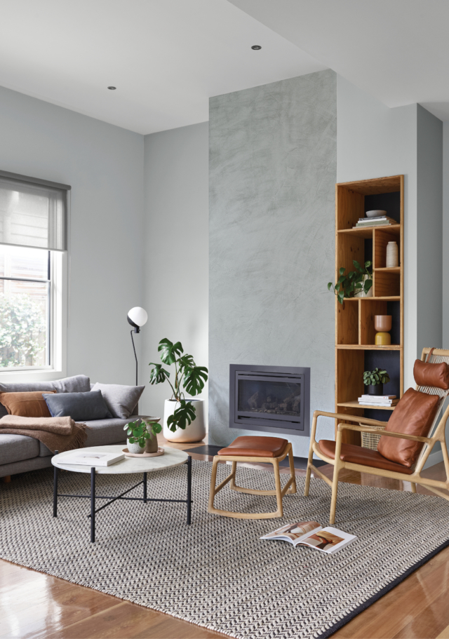 Dulux 'Concrete Effect' in 'Pale Elements' creates the textural effect of polished concrete on the fireplace in this room.