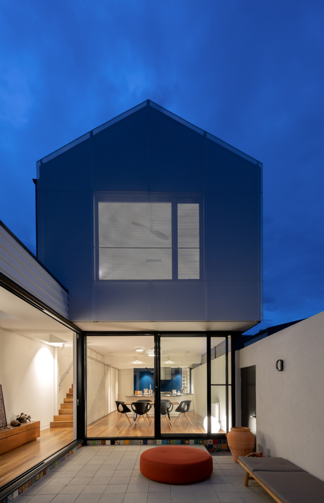 A perforated steel gable provides privacy to the upper level