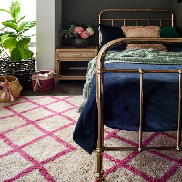A rug can really soften a bedroom. Image: Oh Happy Home