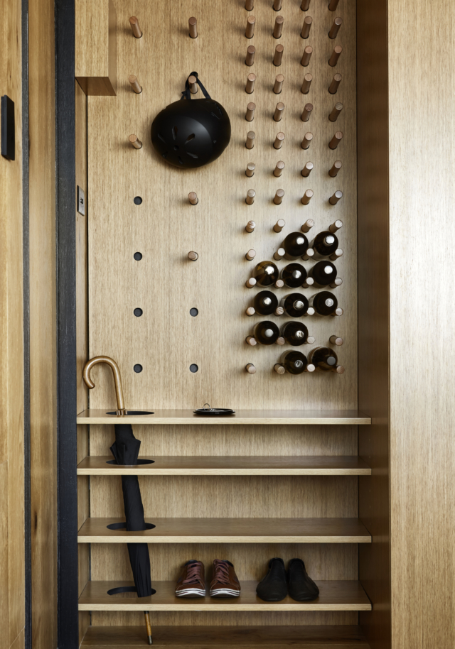 Multipurpose storage at the entry houses coats, shoes a wine rack and even an umbrella stand