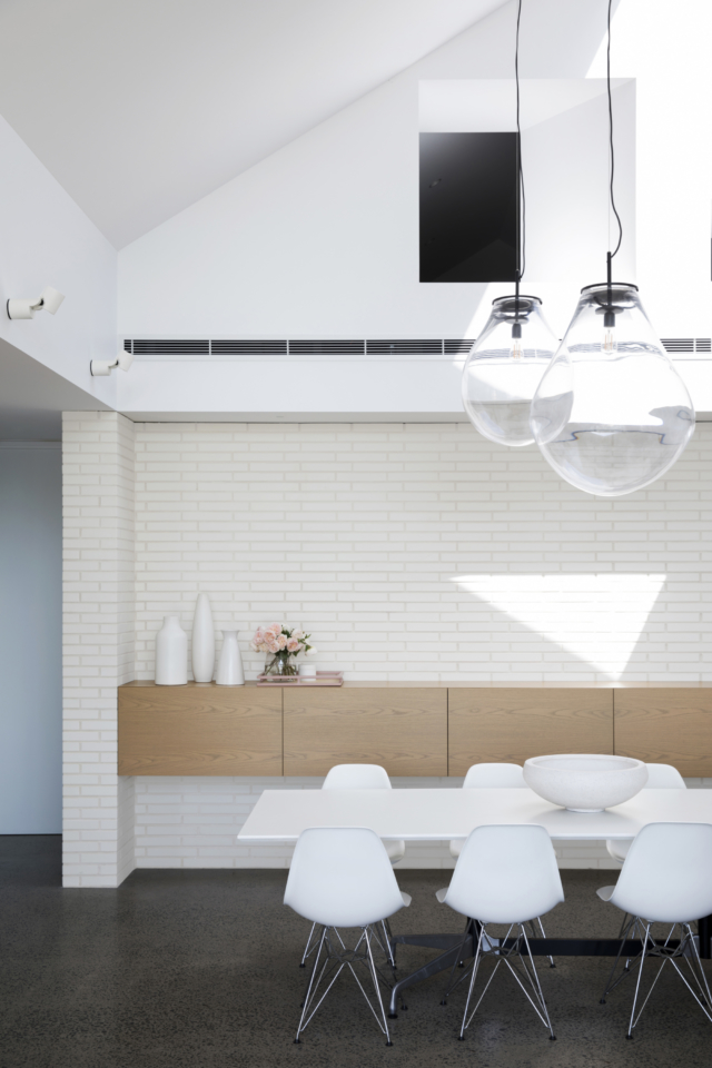 The bricks are beautifully offset by minimalist floating joinery in the dining area