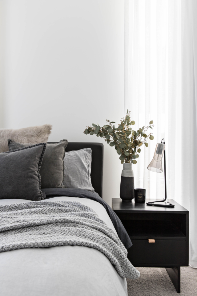 The guest room has a relatively breezier feel courtesy of layers of light grey bed linen.