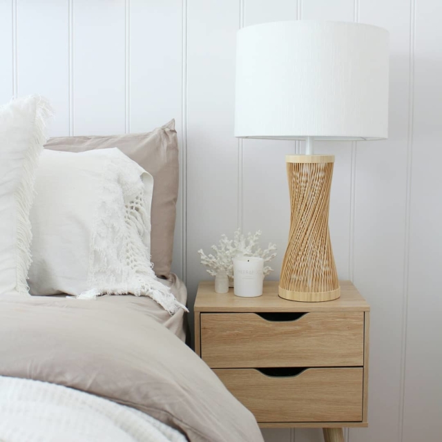 A Kmart bedside looks rather luxe when paired with a Beacon Lighting lamp and a piece of Darren Palmer Collection coral from Myer