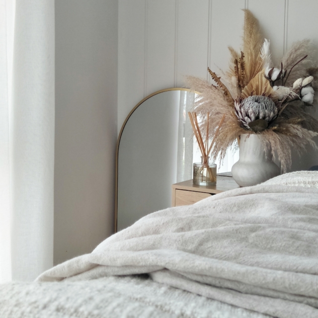 This bedroom features a black Kmart mirror that Zoe painted gold to suit the scheme