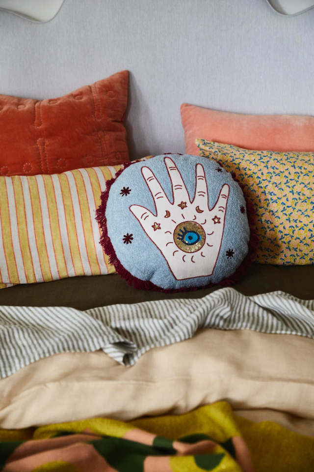 The Habiba Embellished cushion features the iconic hamsa palm