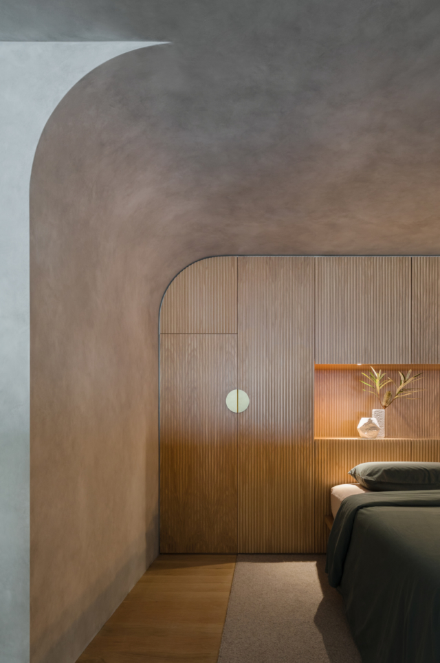 The loft bedroom features this stunning joinery that highlights the curved ceiling