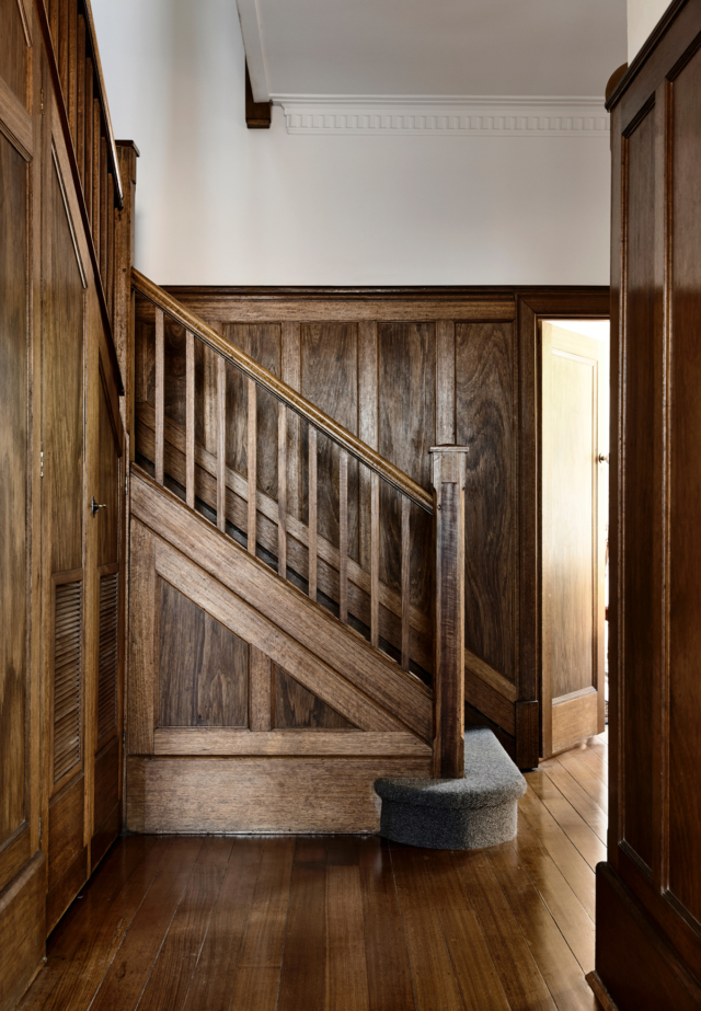 The kitchen takes its timber cues from this original staircase