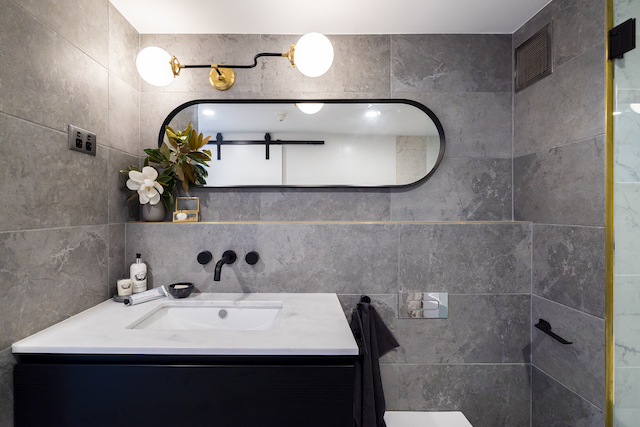 The feature light, from Montauk Lighting Co., and mirror are a highlight of the bathroom