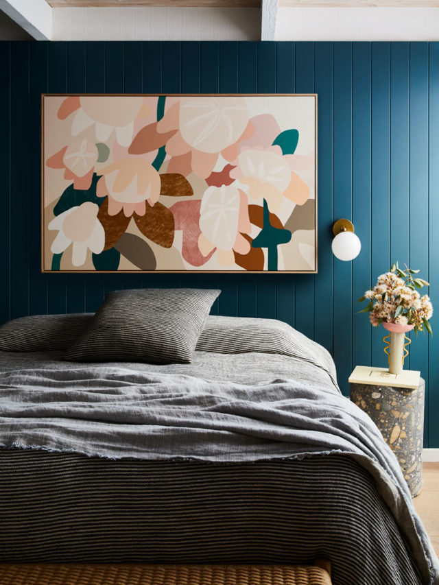 A Kimmy Hogan piece pops on the dark bedroom wall