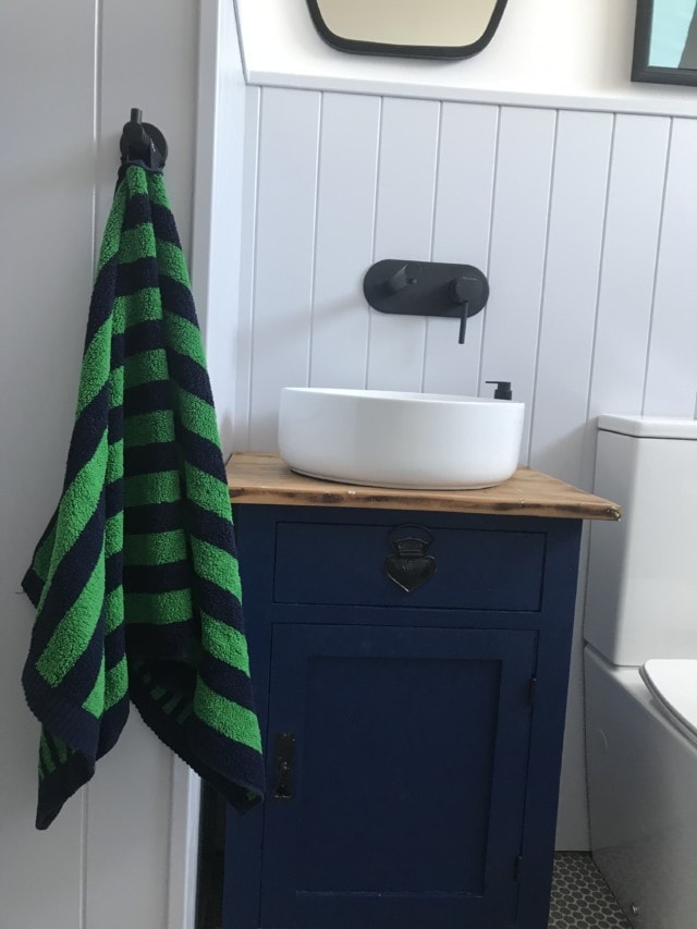 The bathroom vanity was made from an upcycled bedside table found on Gumtree