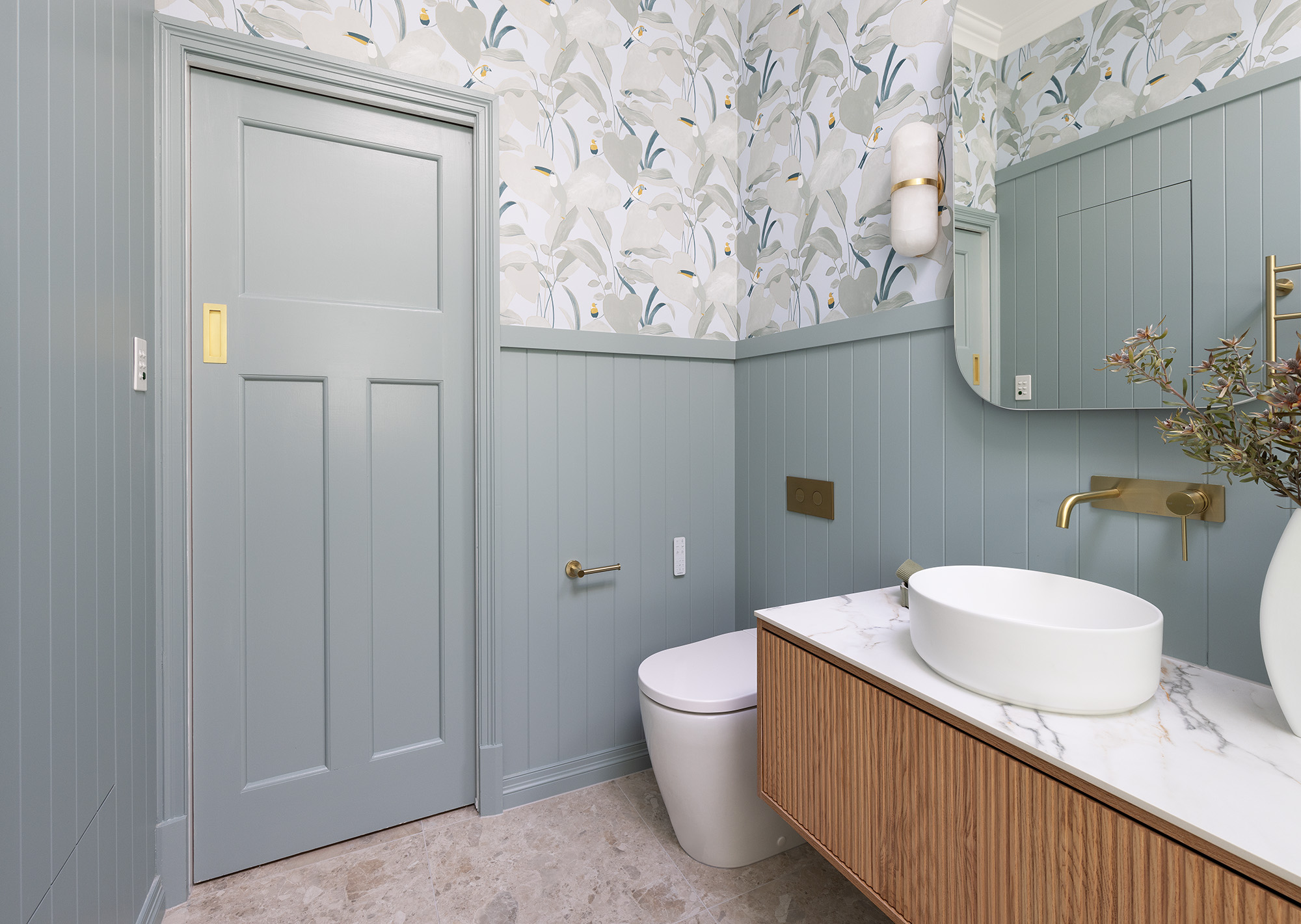 A stunning sage green bathroom transformation with wallpaper The