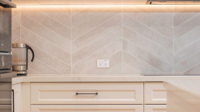Kitchen with feature pendant lighting and discreetly placed power points after an electrical upgrade